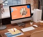A modern home office setup with a desktop computer displaying a client testimonial on the screen.